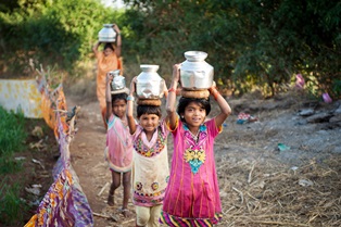 Children carrying precious water smaller